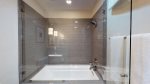 Tertiary bathroom with step-in bathtub shower combo